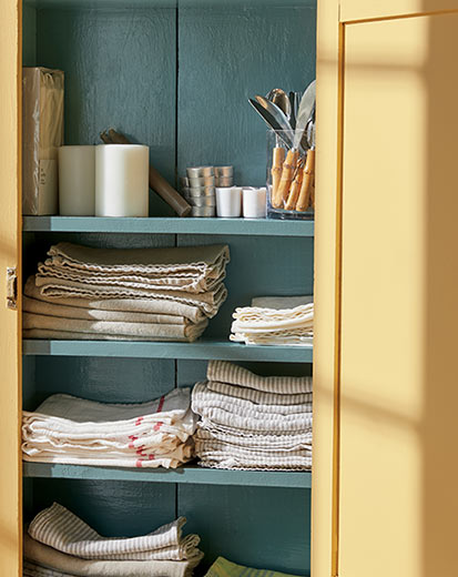 tea towels neatly packed in a kitchen cupboard